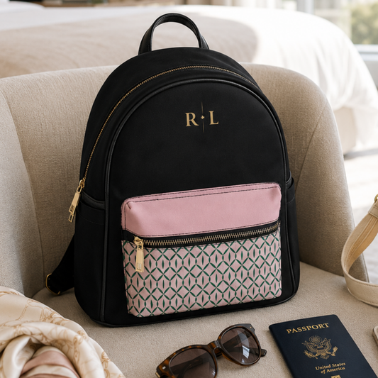 Black vegan leather mini backpack with pink and green front pocket and personalized gold two-initial monogram.