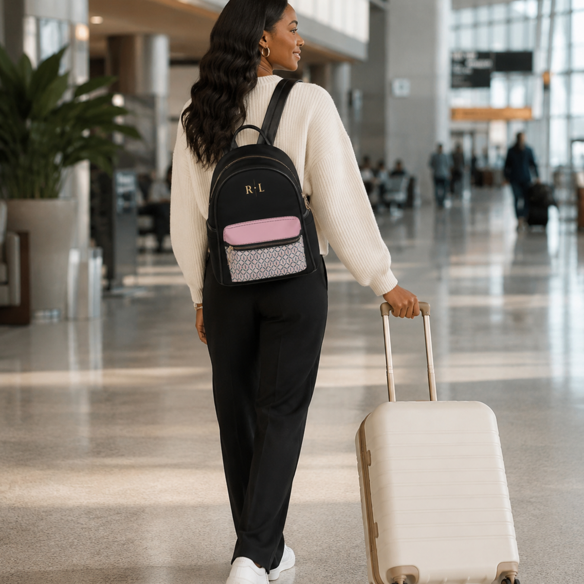 Personalized black, pink and green monogram mini backpack styled as a women's travel bag.