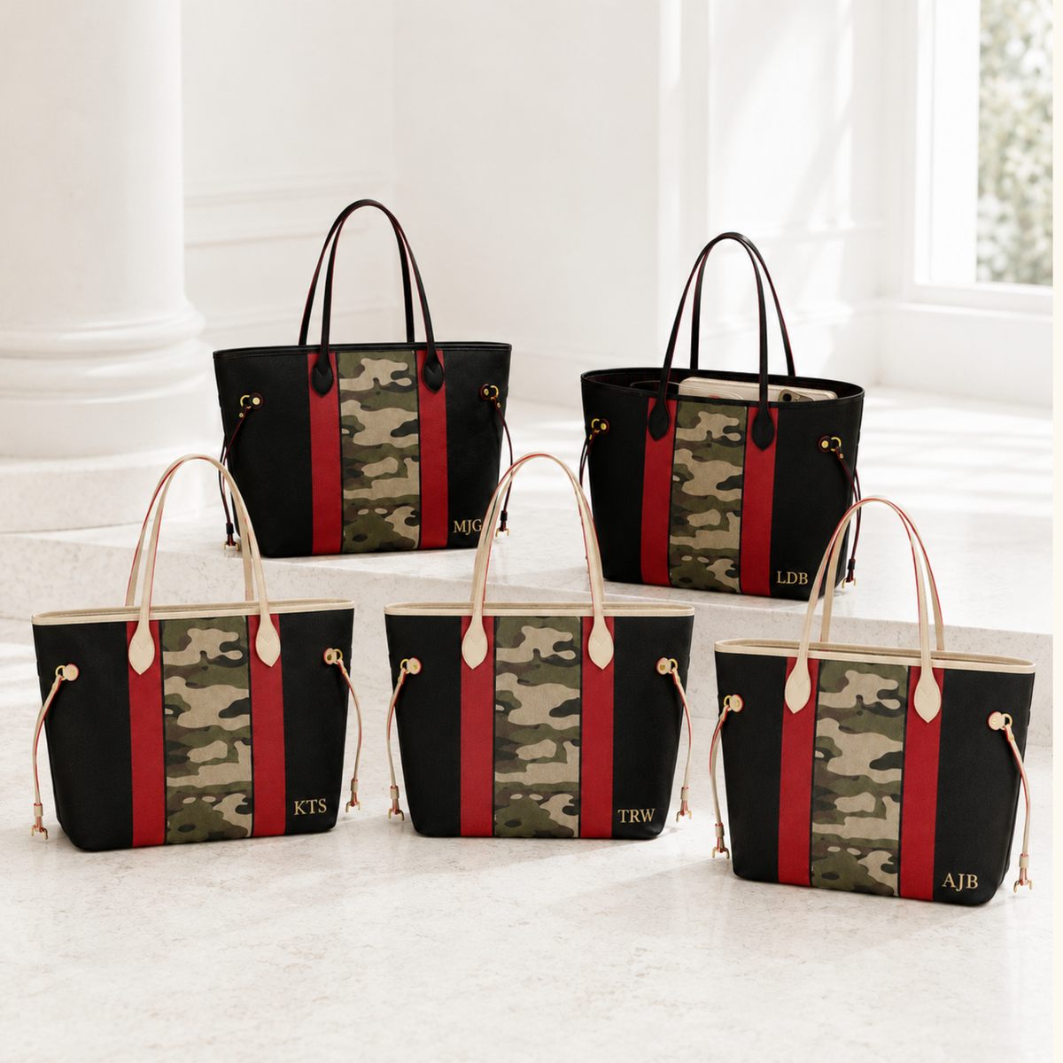 Multiple crimson, black and camouflage handbags personalized with different three-letter monograms for group gifting.