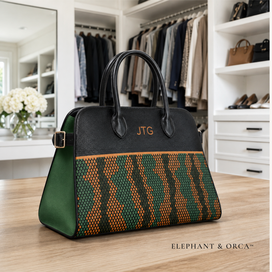 Personalized black and green vegan leather handbag with orange and green patterned front panel and custom monogram.