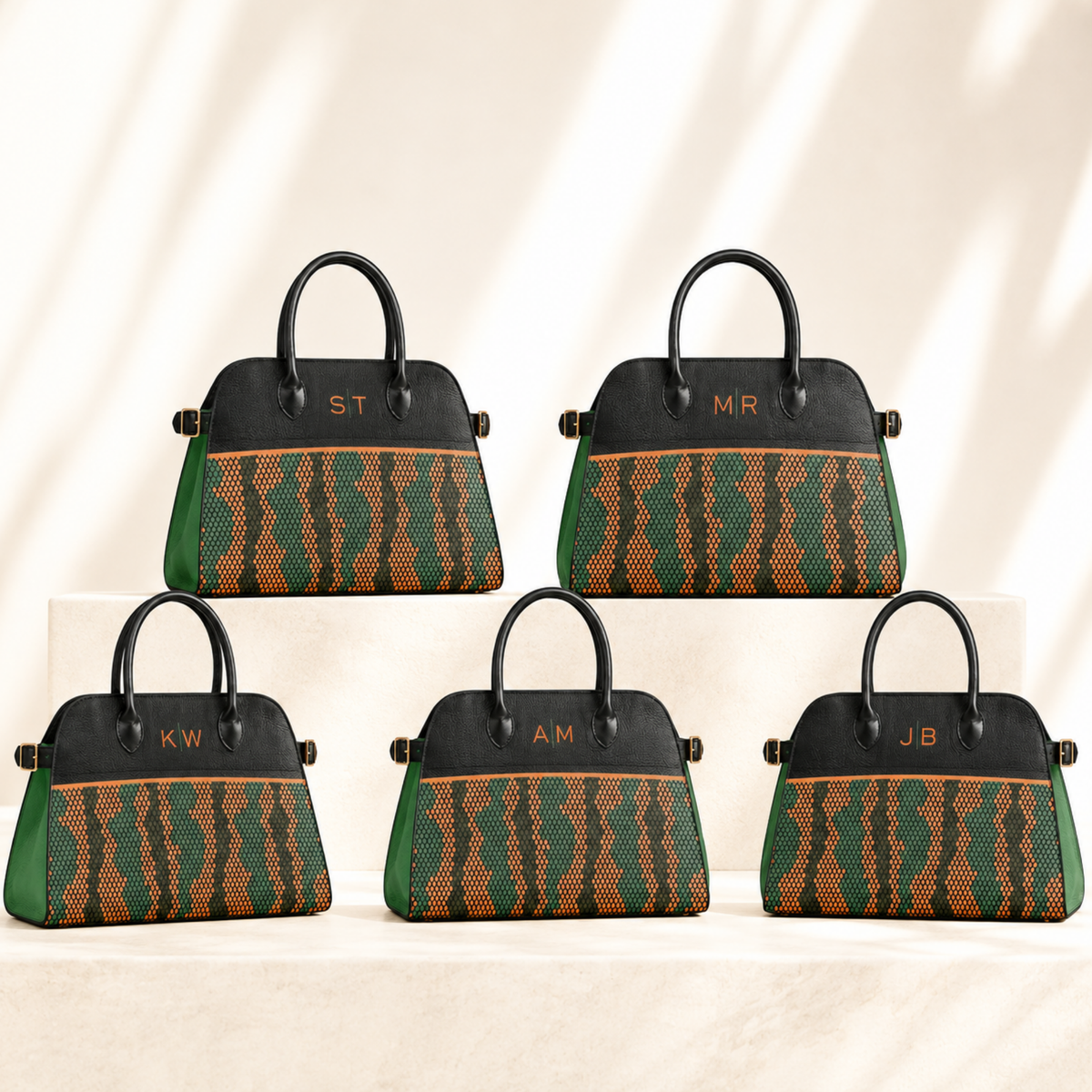 Multiple orange and green handbags personalized with different monograms for coordinated alumni and group gifting.